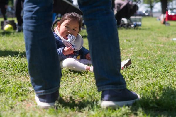 Toddler with ReNU syndrome Toddler with ReNU syndrome sitting in grassy park playing with a toy zebra.