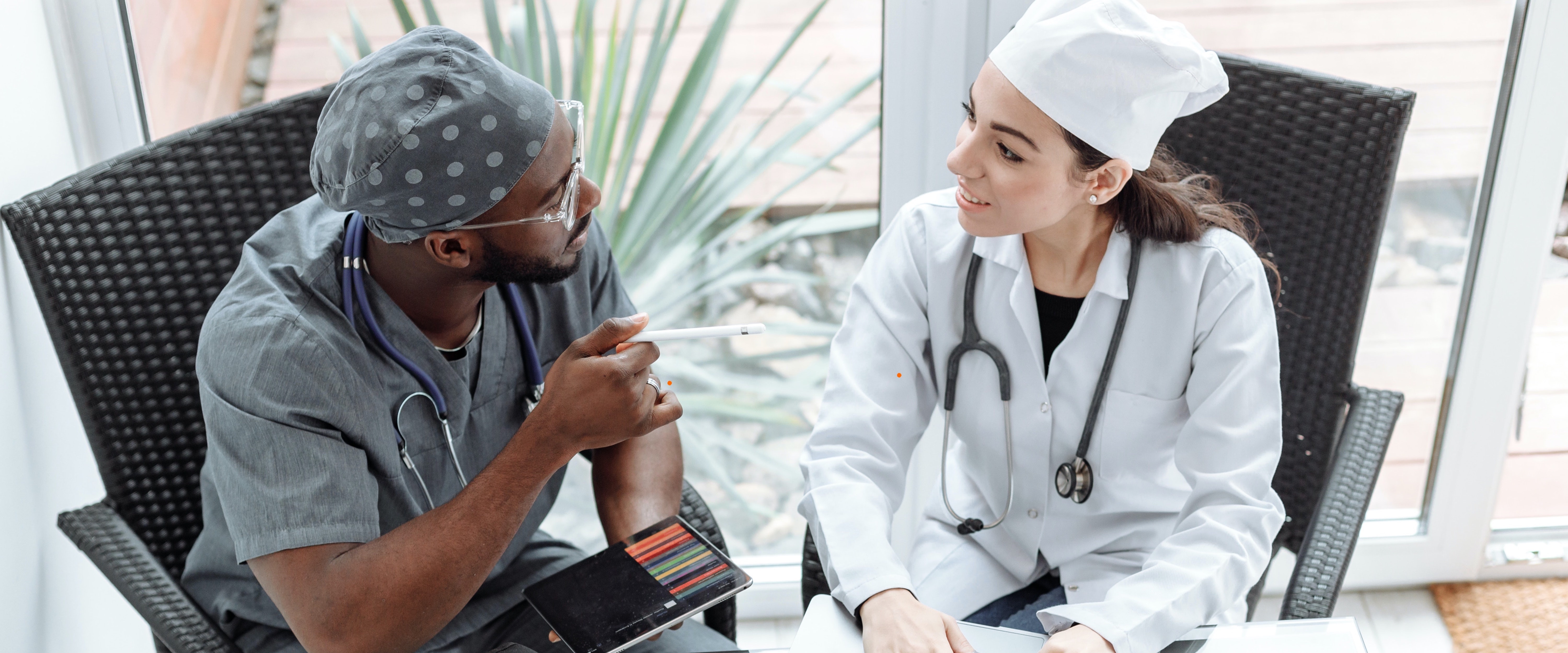 Two doctors sitting at table having a discussion