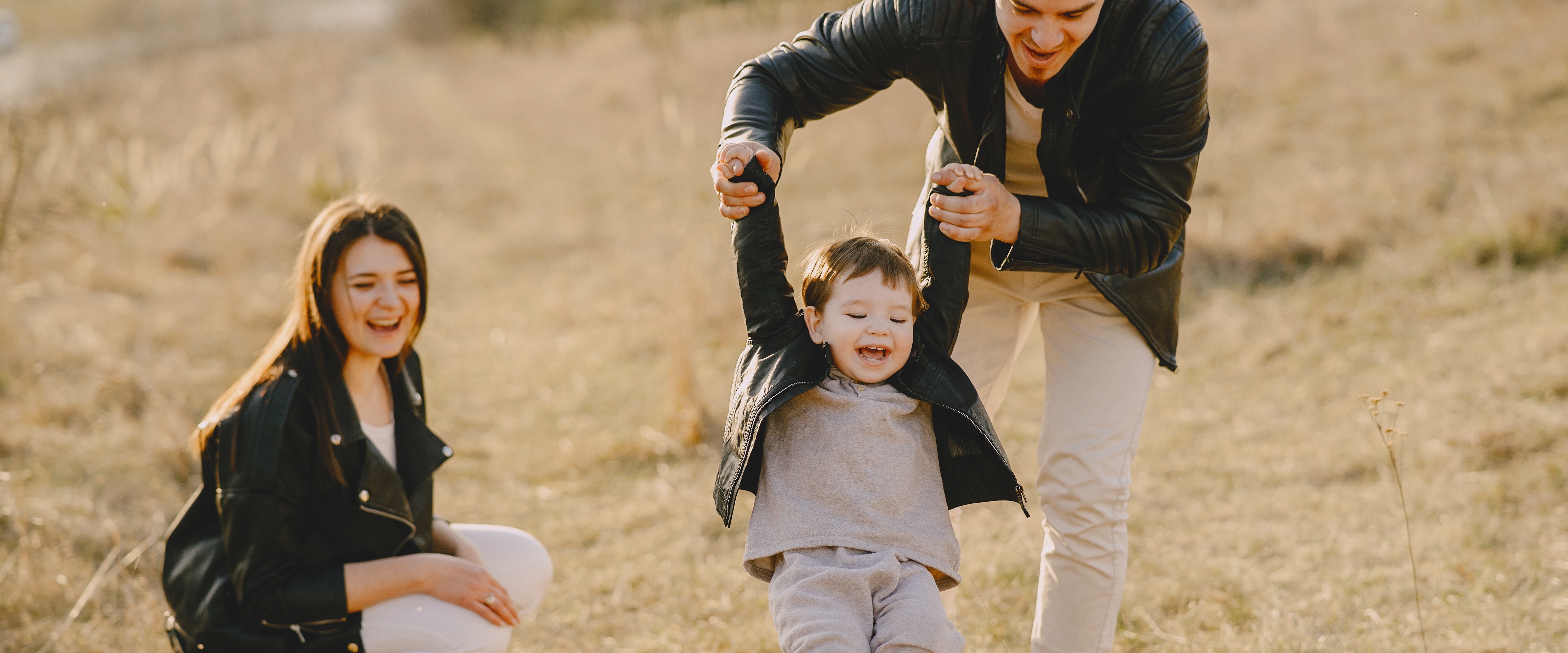 Man and woman playing with child